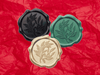 Forest Green, Black and Gold Wax Seals Featured on Dark Red Tissue Paper